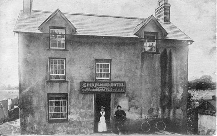 The Ship Aground Hotel, with people gathered by the door